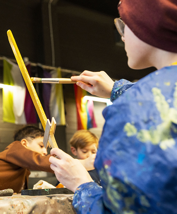 Strákur málar sverð á safni í vetrarfríi.