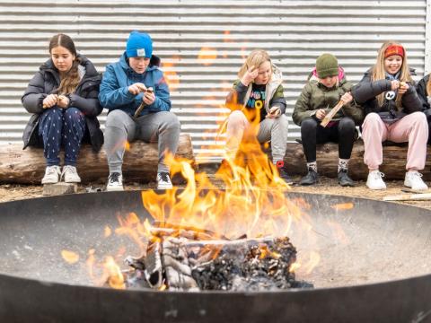 Children sitting around a campfire.