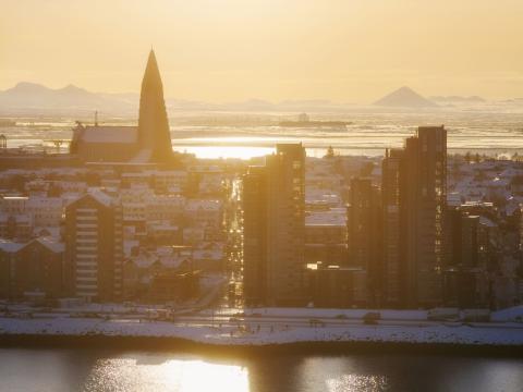 aerial view of Sæbraut and Hallgrímskirkja. Winter, late afternoon sun. Keilir and Reykjanes visible in the distance.