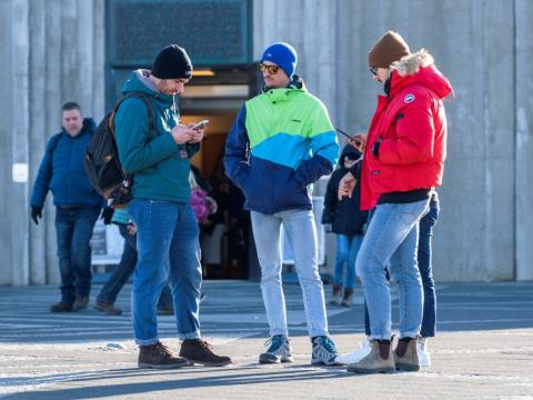 People using phones in front of Hallgrímskirkja church