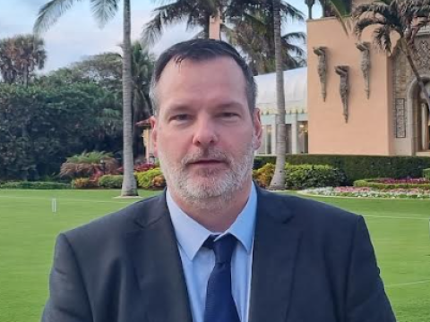 Hilmar Ingi Jónsson, data protection officer for Reykjavík City. Pictured abroad wearing a suit with palm trees in the background.