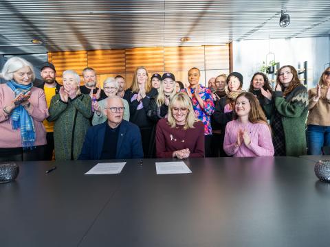 A group of people at the signing ceremony in City Hall