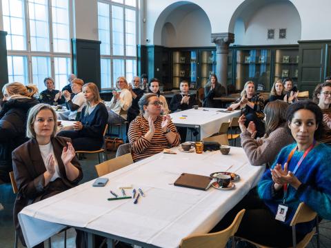 From the conference on LGBT+ safety at the House of Collections Oct. 29, 2025. People seated at tables in the hall.