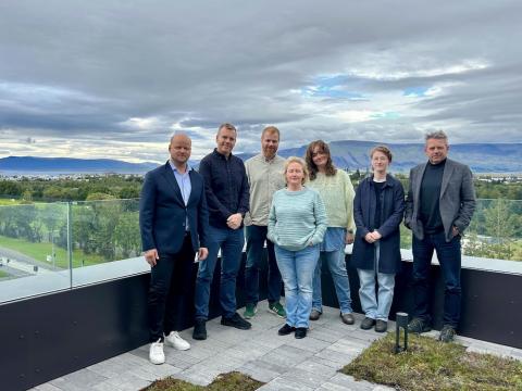 people on balconies with landscape in the background