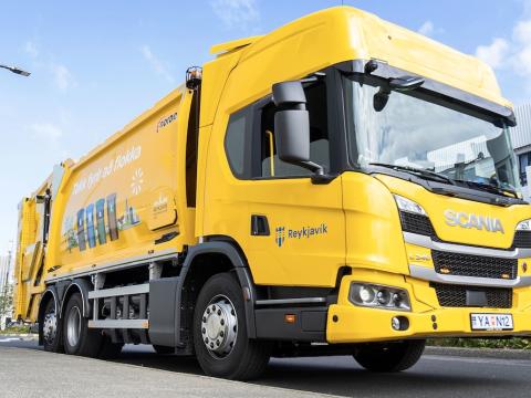 A yellow waste collection vehicle.