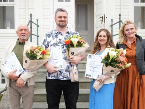 Þrír einstaklingar með blóm ásamt borgarstjóra