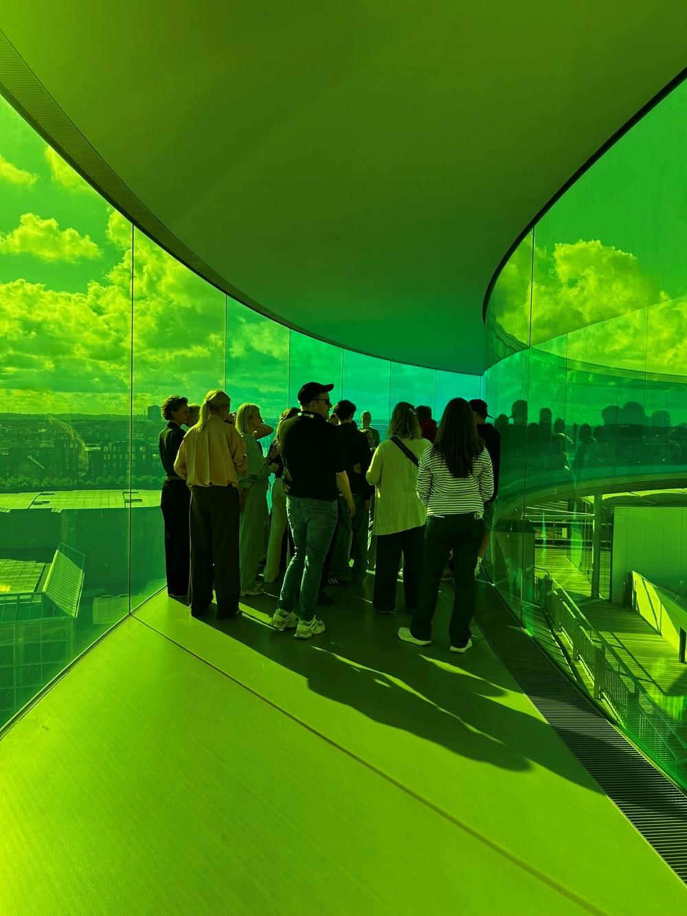 People in green corridors at an art museum in Aarhus.
