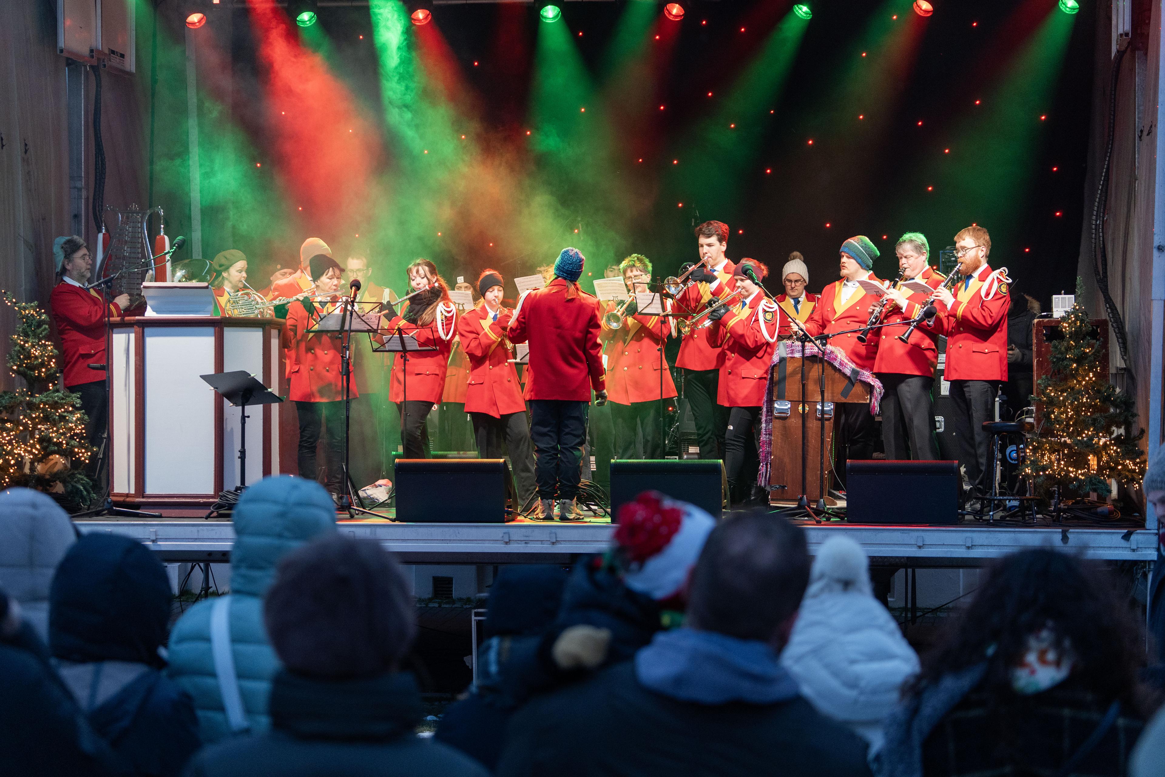 Brass band performs on festive stage
