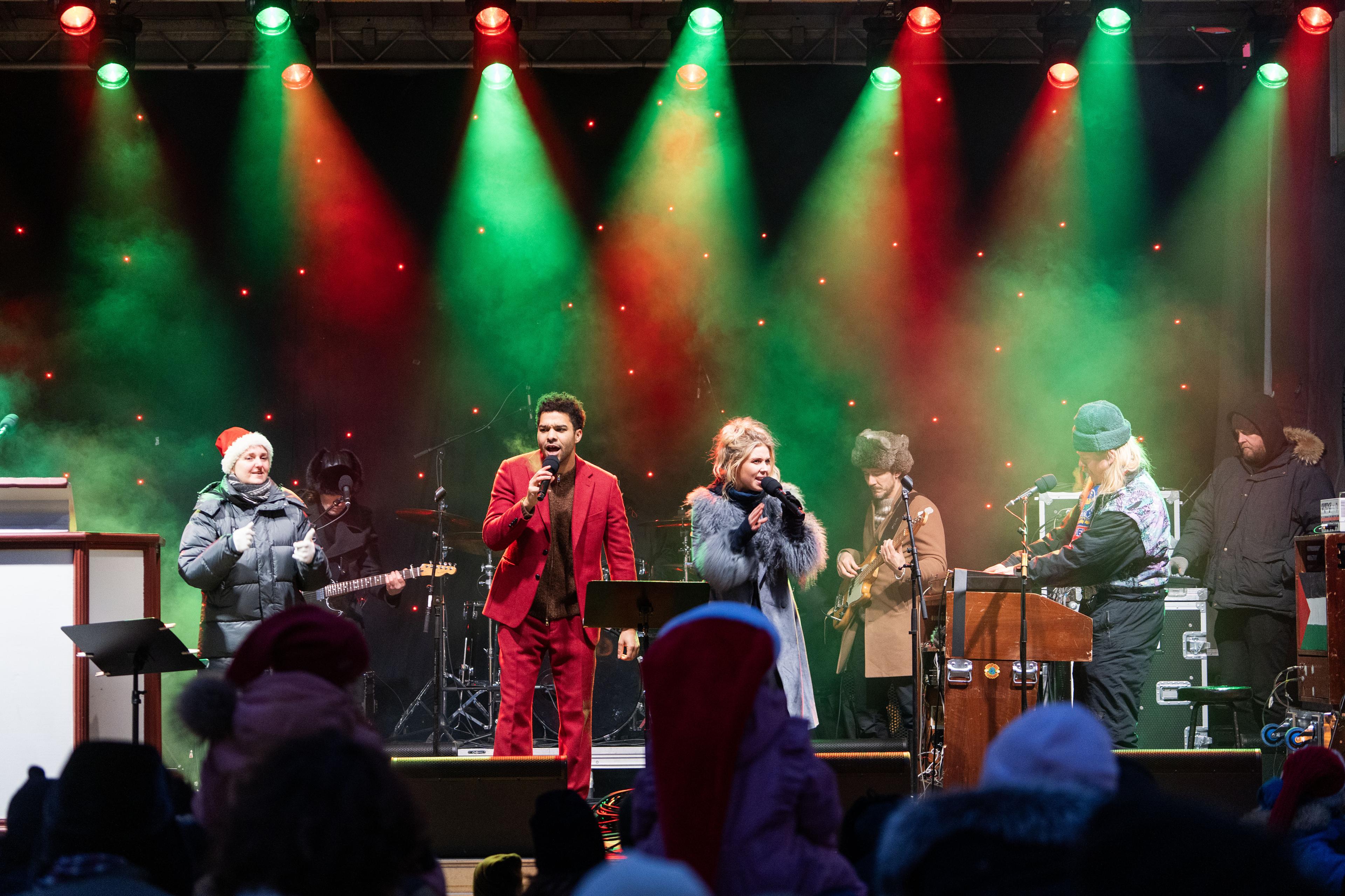 Singers and band on festive stage