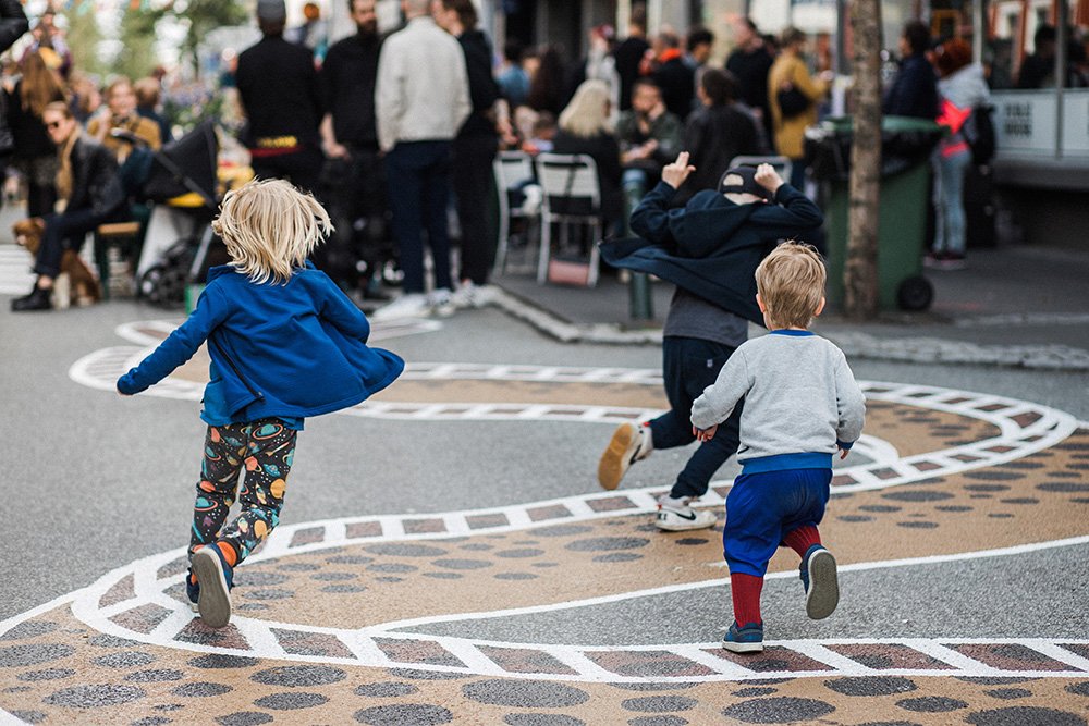 Kids playing on a pedestrian street.
