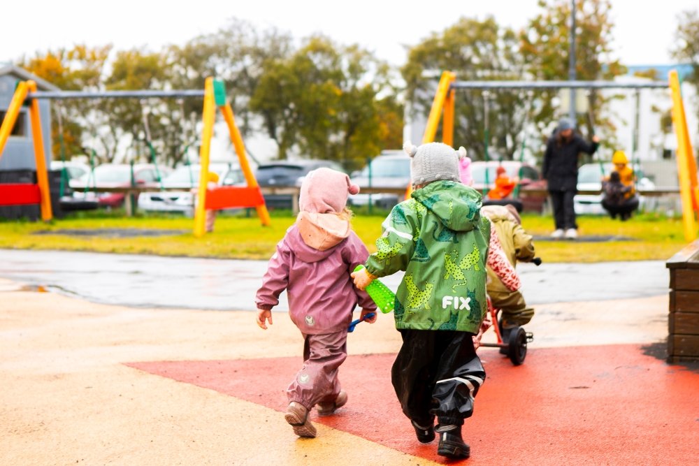 Children and playground equipment on Laugasól's grounds.