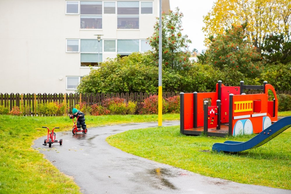 Child and playground equipment on Laugasól's grounds.