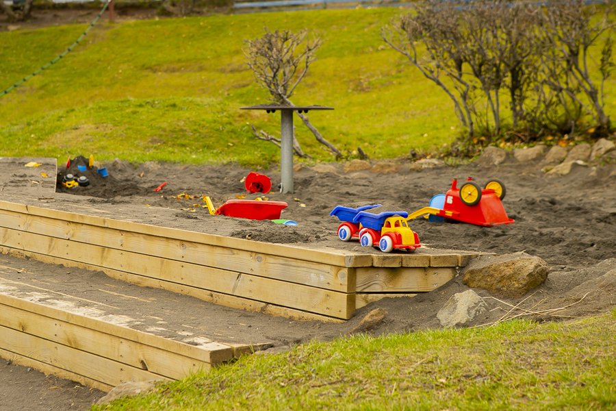 Sandbox and playground equipment on Seljakot's grounds.