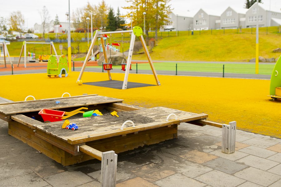Sandbox and playground equipment on Seljakot's grounds.
