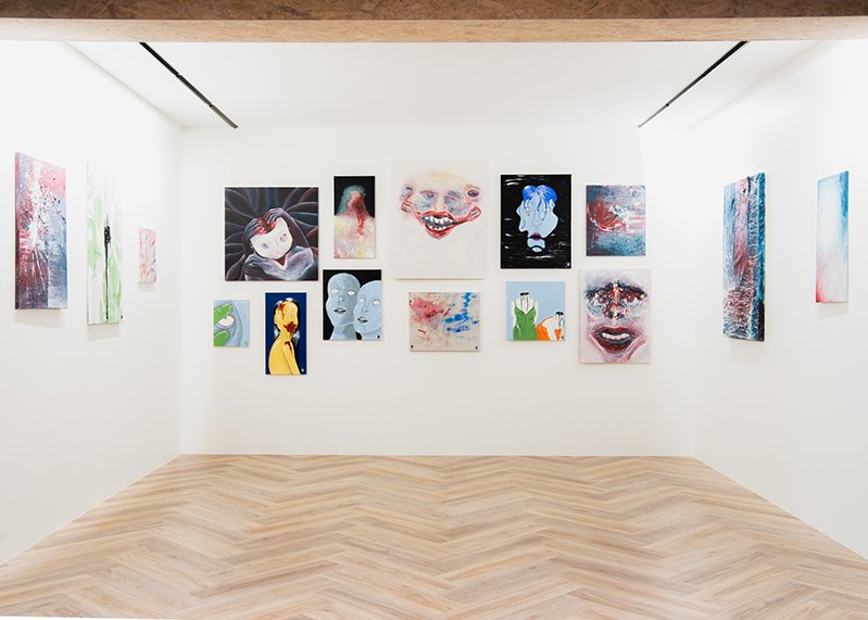 Photo of the gallery at Hitt Húsið. Many pictures on the wall.