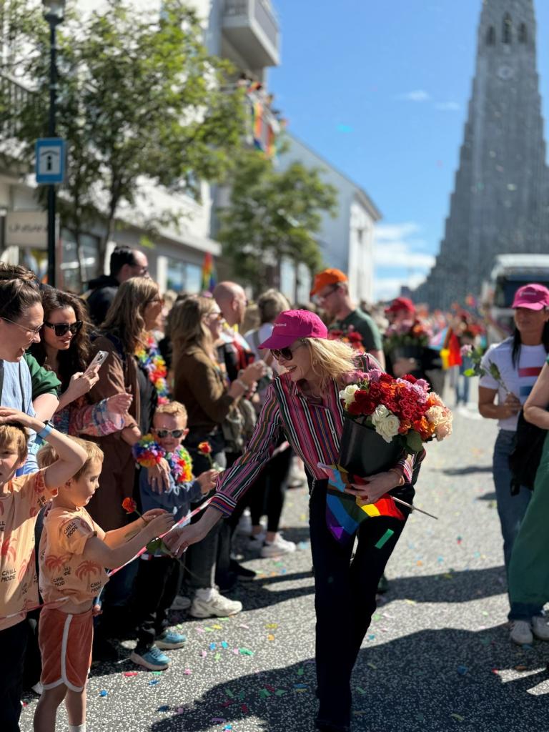 Mayor Heiða Björg Hilmisdóttir giving roses to participants in the Reykjavík Pride Parade.