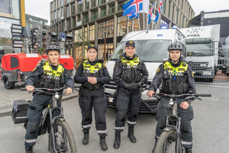 Four police officers — two on bicycles, two on foot. In the city center during Culture Night.