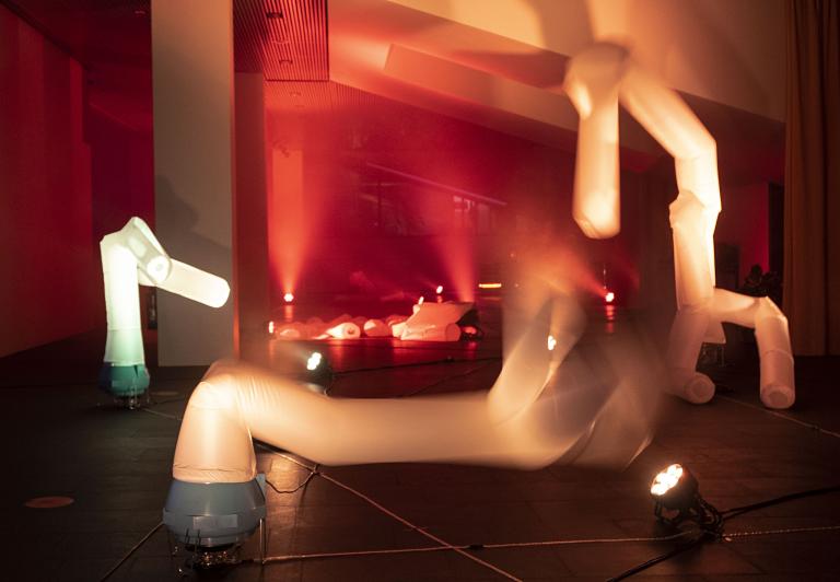 Artwork at city hall, Tjarnarsalur, during the 2022 Winter Lights Festival. White "figures" that inflated with air and danced back and forth.