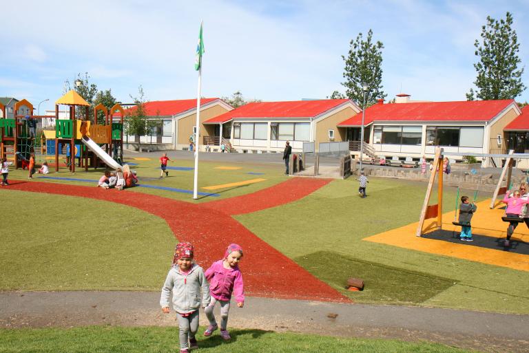 Children playing on the grounds of Laugasól Preschool.