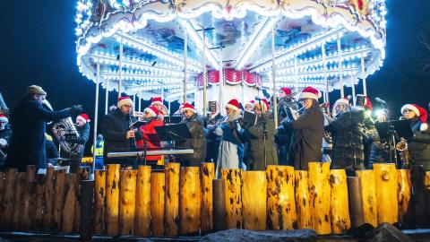 The Workers' Brass Band plays in a brightly lit carousel in The Valley of Lights in Laugardalur, at the opening of Christmas Valley 2024.
