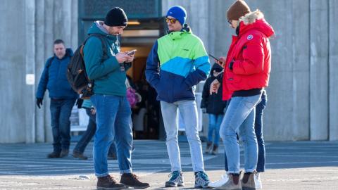 People using phones in front of Hallgrímskirkja church