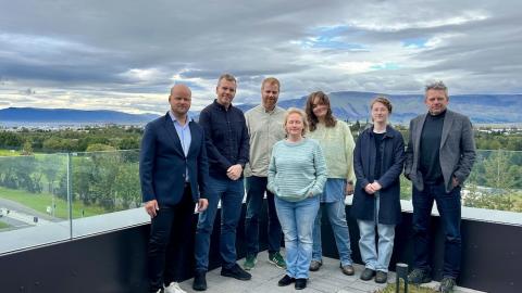 people on balconies with landscape in the background