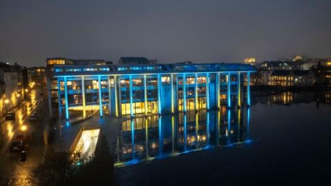 Reykjavík City Hall illuminated in the colors of the Ukrainian flag