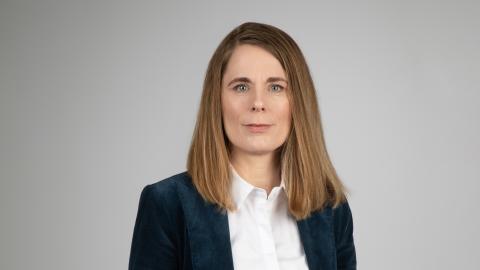Ingunn Ólafsdóttir, internal auditor for Reykjavík City. Portrait photo, gray background.