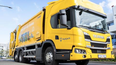 A yellow waste collection vehicle.