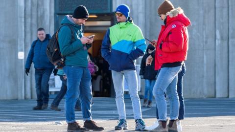 Tourists with cellphones outside Hallgrímskirkja